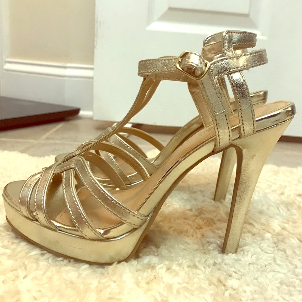 Brash gold high heeled shoes.